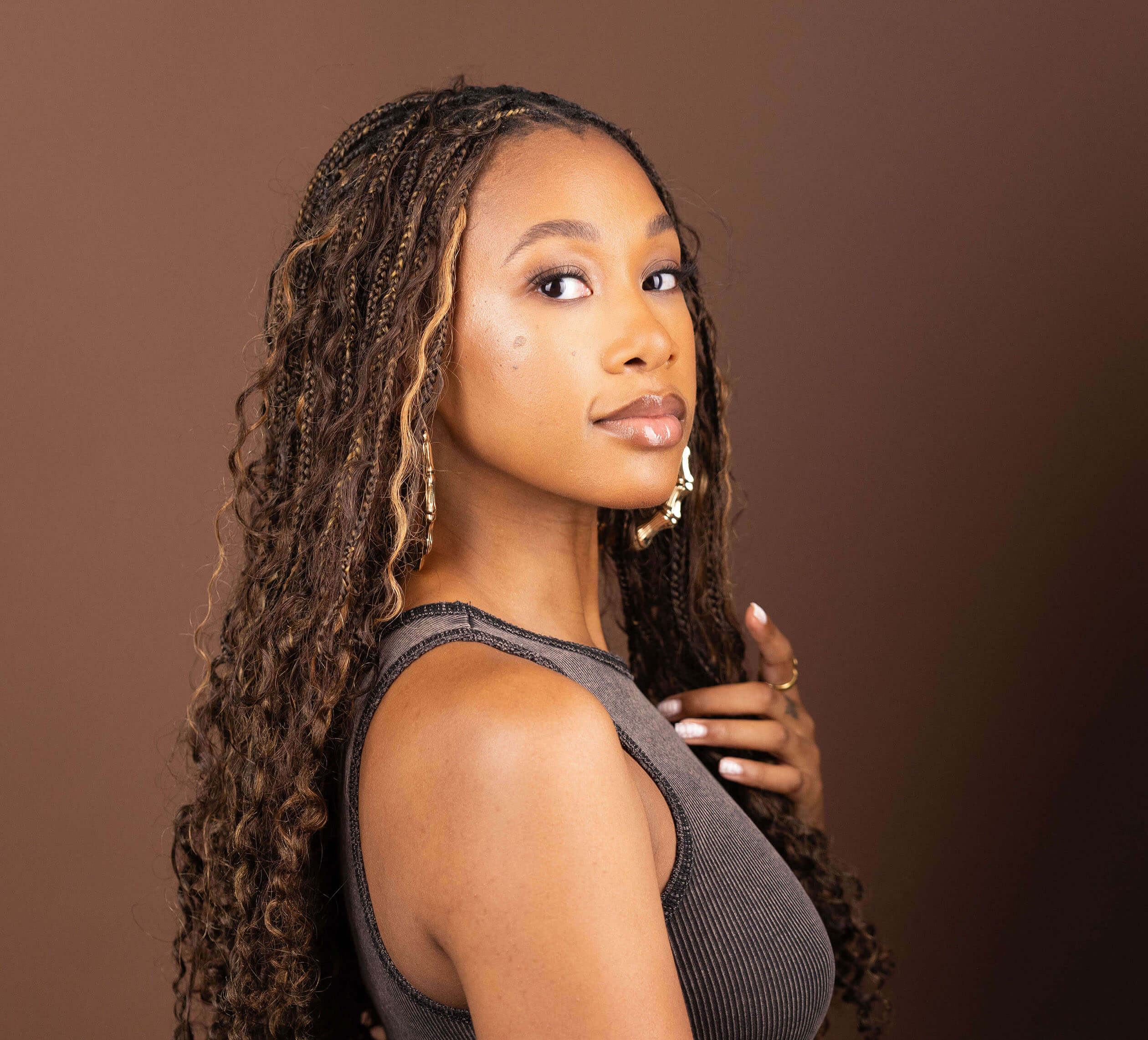 Model showcasing Blhair color-blended braiding hair in the color Amber Glow: warm, rich, golden amber hues.