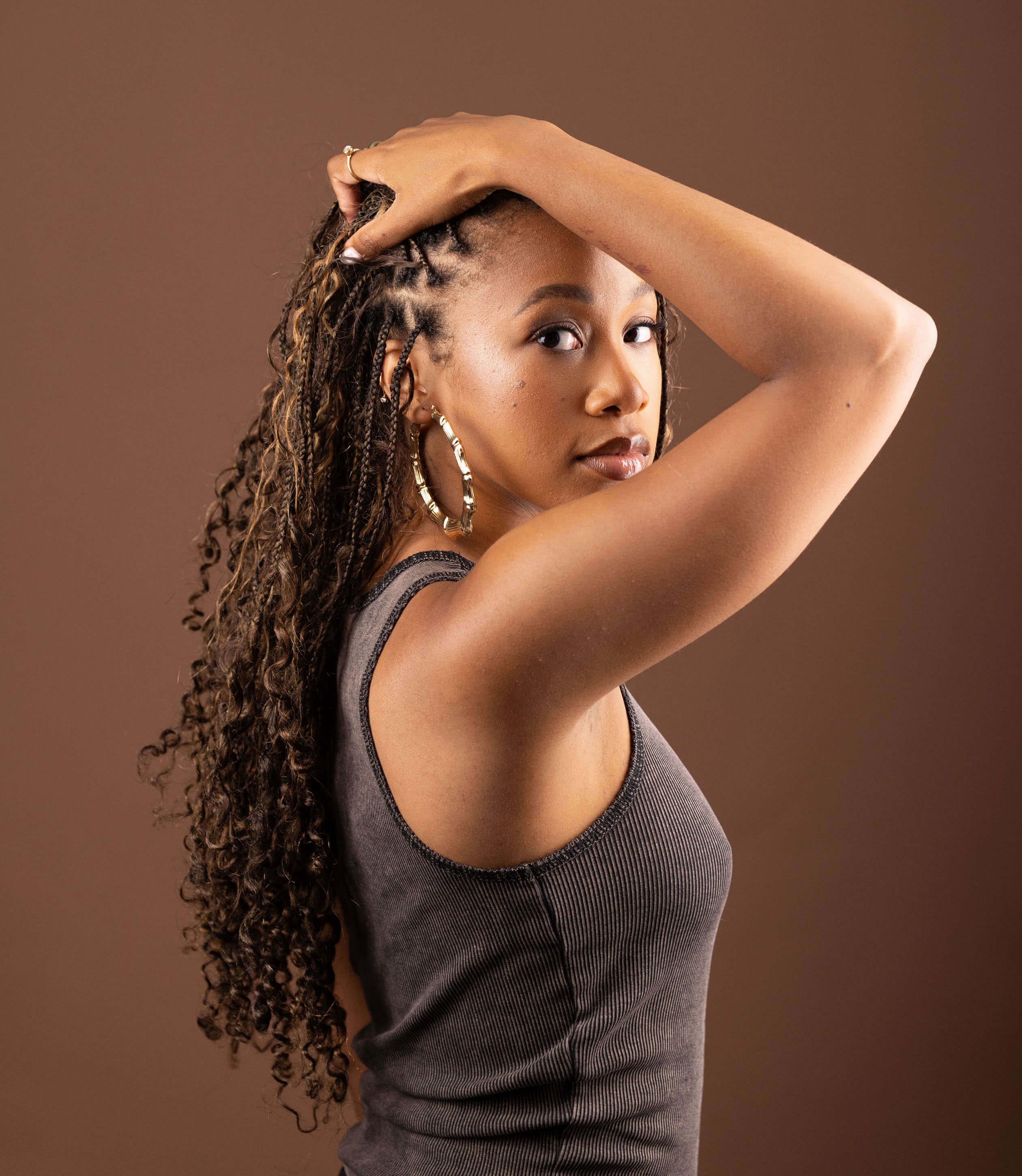 Model showcasing Blhair color-blended braiding hair in the color Amber Glow: warm, rich, golden amber hues.