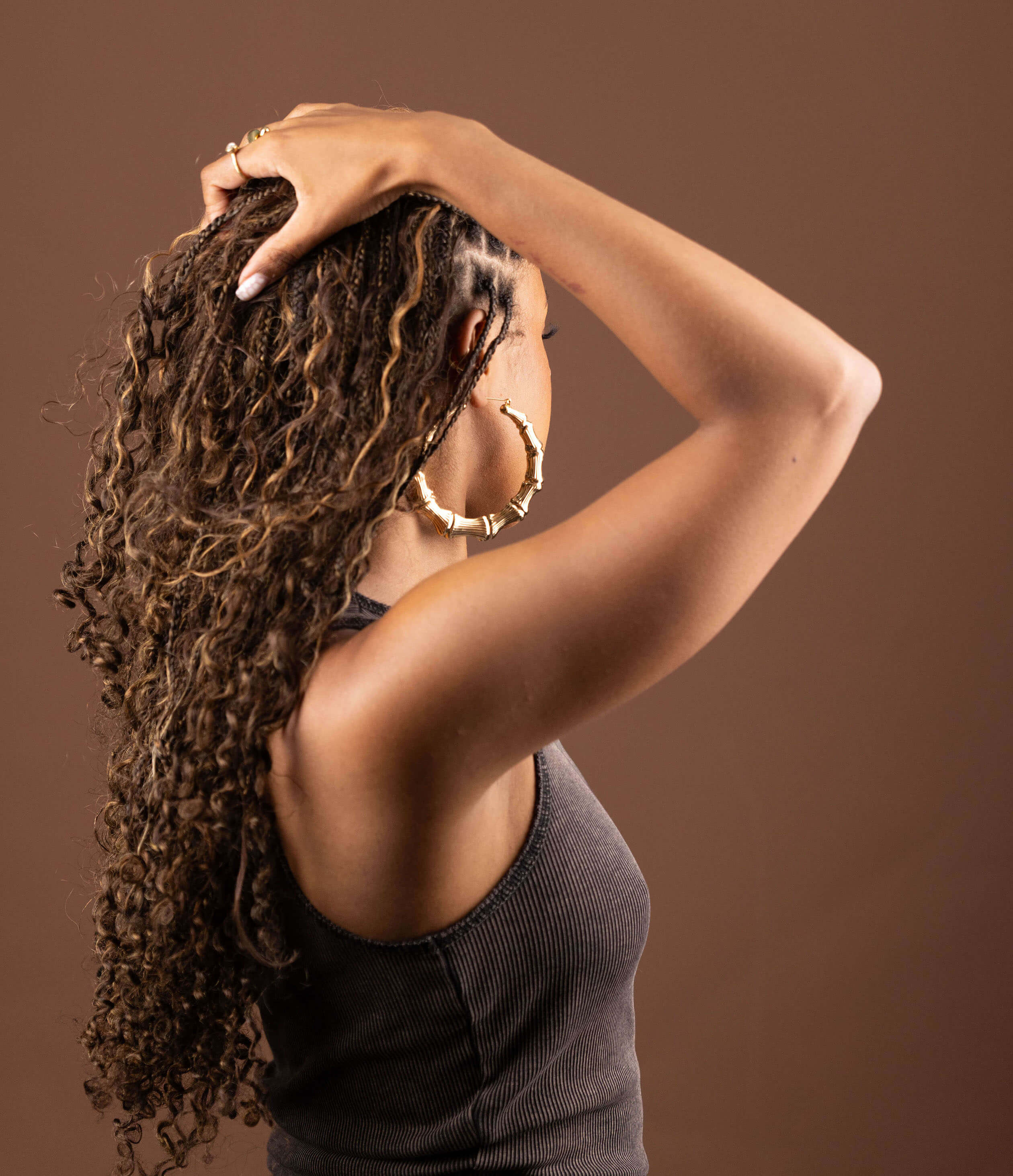 Model showcasing Blhair color-blended braiding hair in the color Amber Glow: warm, rich, golden amber hues.