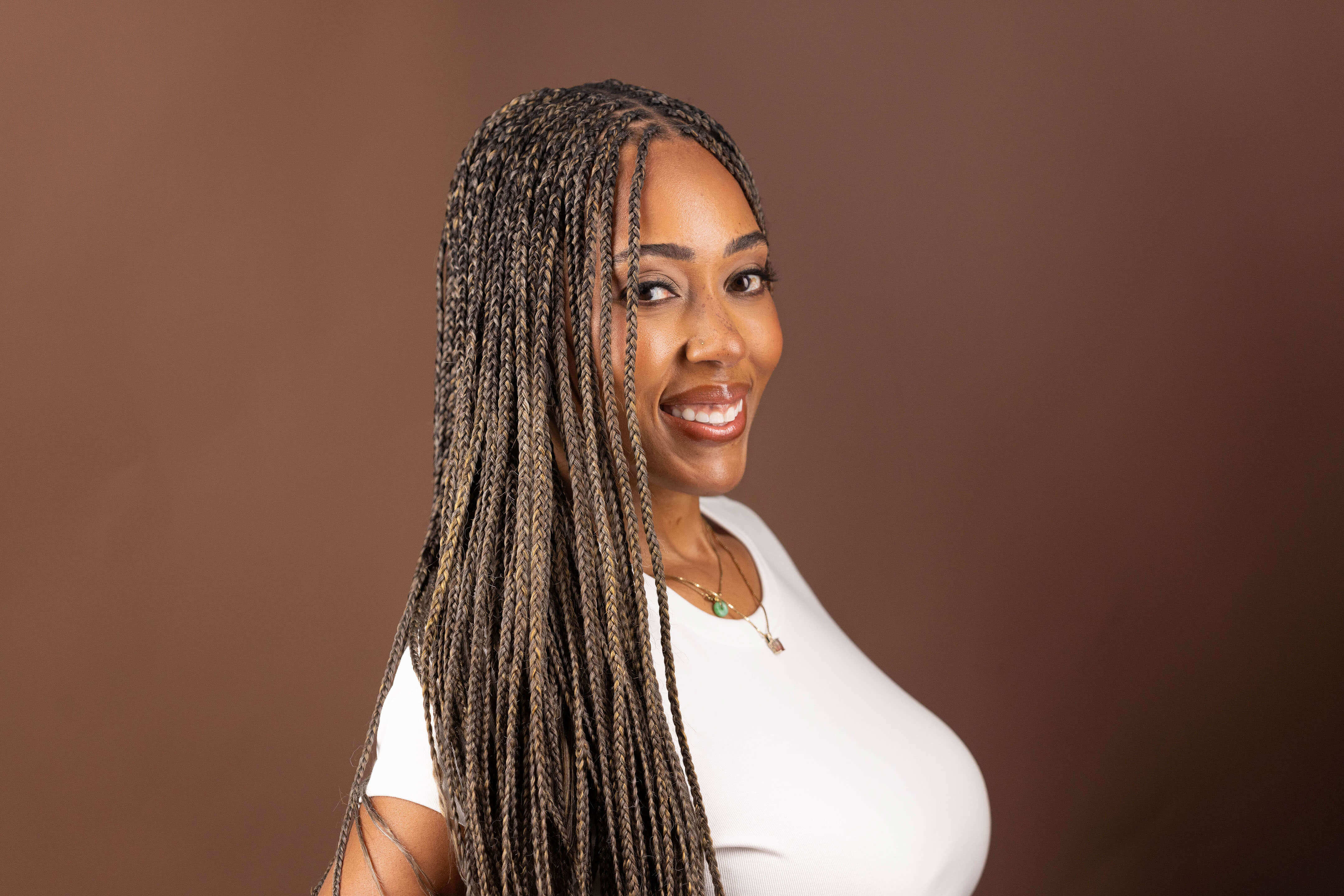 Autumn showcasing Blhair color-blended braiding hair in the color Golden Hour: warm, rich, golden hues.