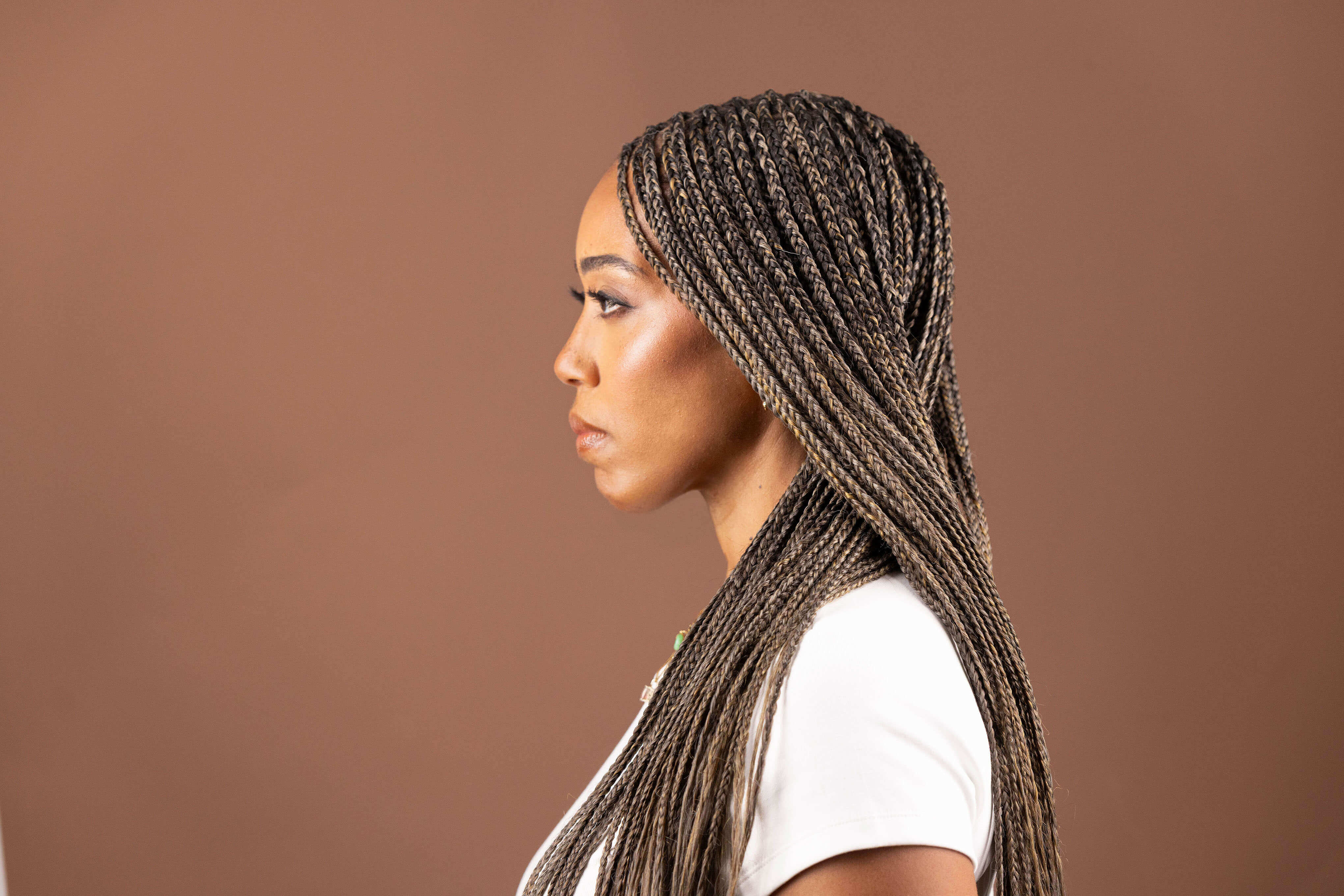 Autumn showcasing Blhair color-blended braiding hair in the color Golden Hour: warm, rich, golden hues.