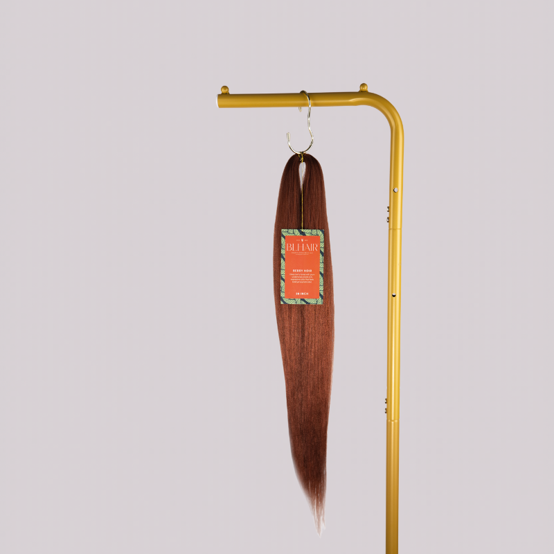 Blhair™ Berry Noir braid hair bundle hanging on gold display stand against neutral background.