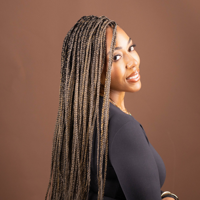 Model wearing long Blhair™ Golden Hour box braids featuring soft brown-blonde tones and natural-looking dimension.