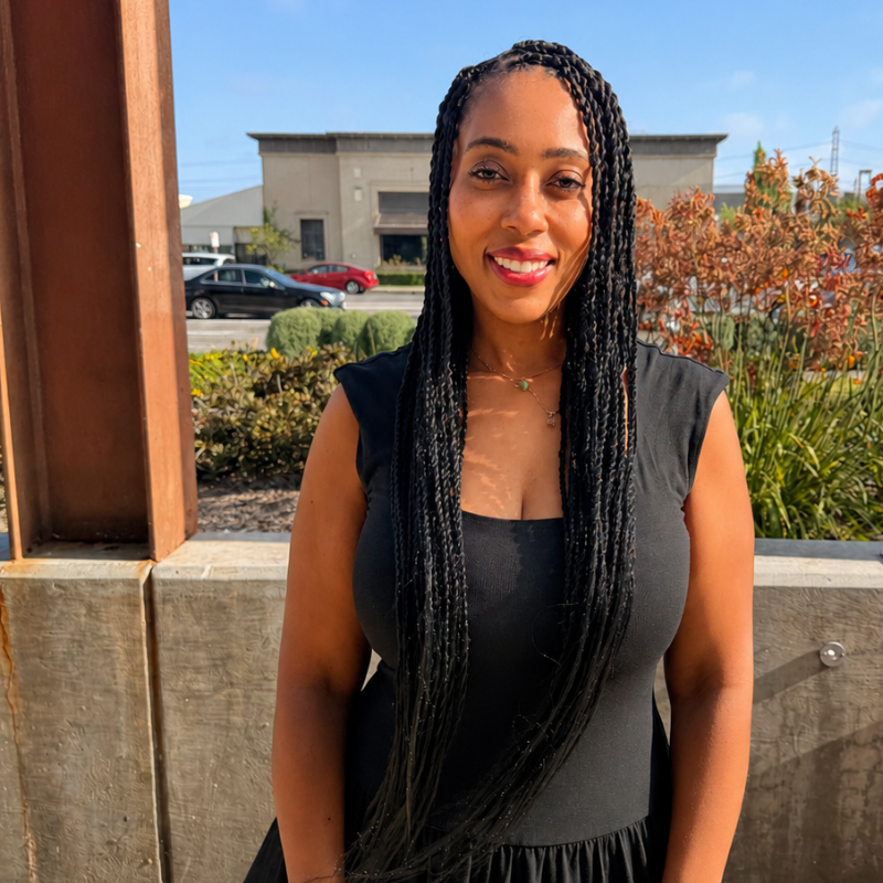 Model wearing long Blhair™ Onyx Noir twists outdoors, showing the deep near-black color in sunlight.