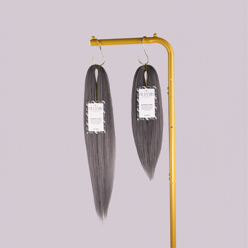 Blhair™ Smoked Silver braid hair bundles displayed on gold stand against neutral background.