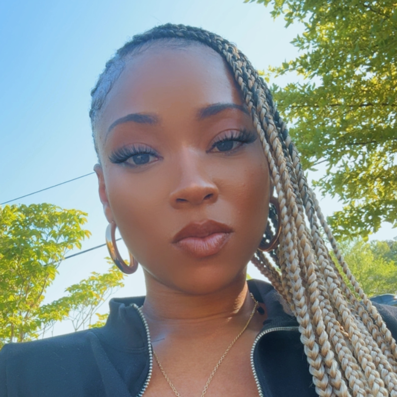 Woman outdoors wearing Blhair™ Sol Glow braids with soft blonde tones in natural sunlight.