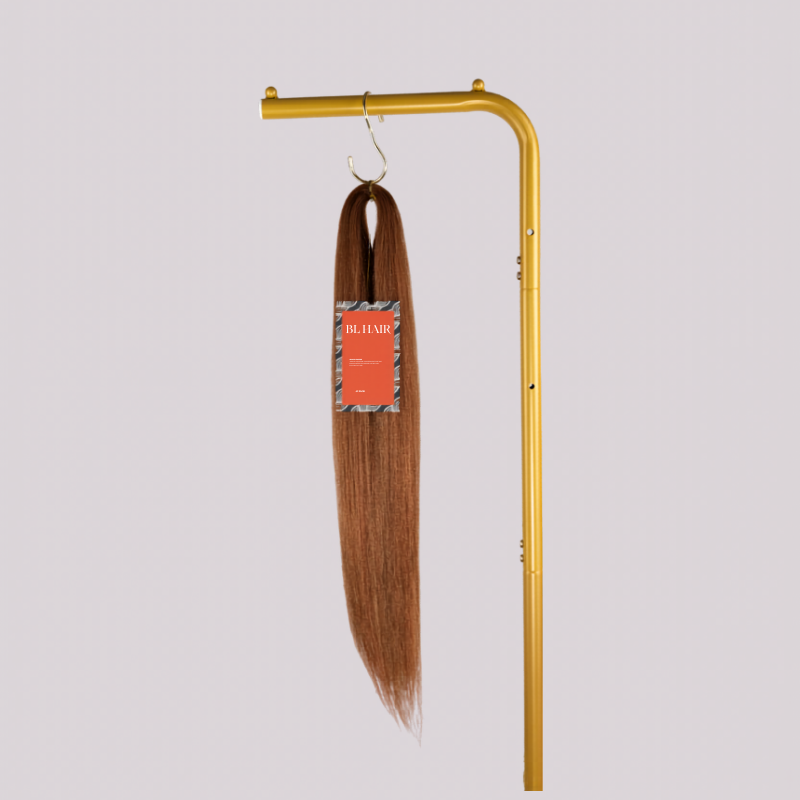 Blhair™ Spiced Toffee braid hair bundle hanging on gold display stand against neutral background.
